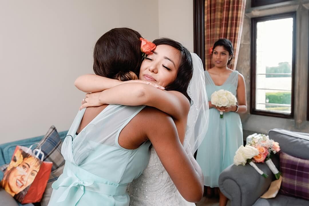 bride hugging bridesmaid