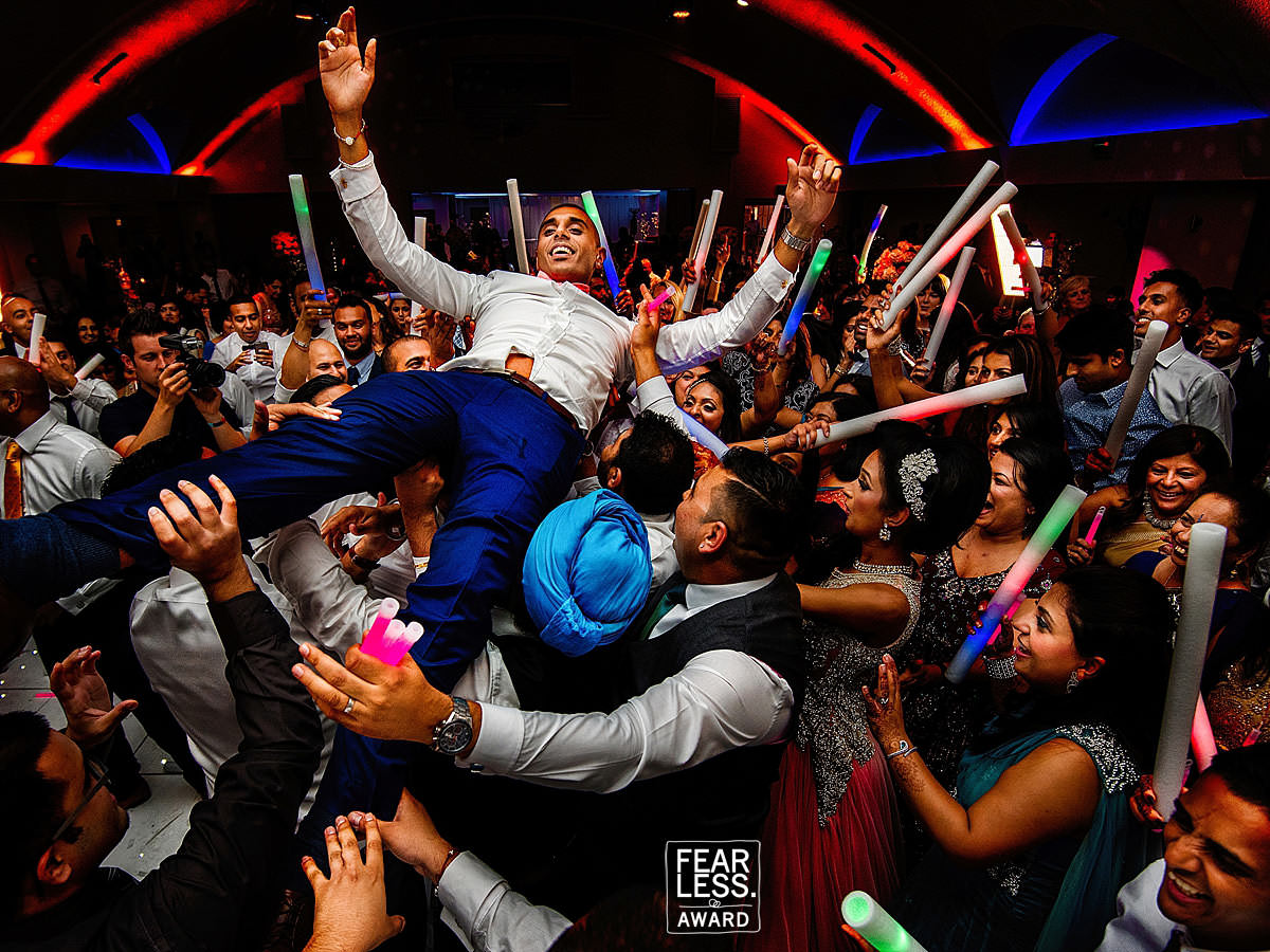 groom crowd surfing during the party