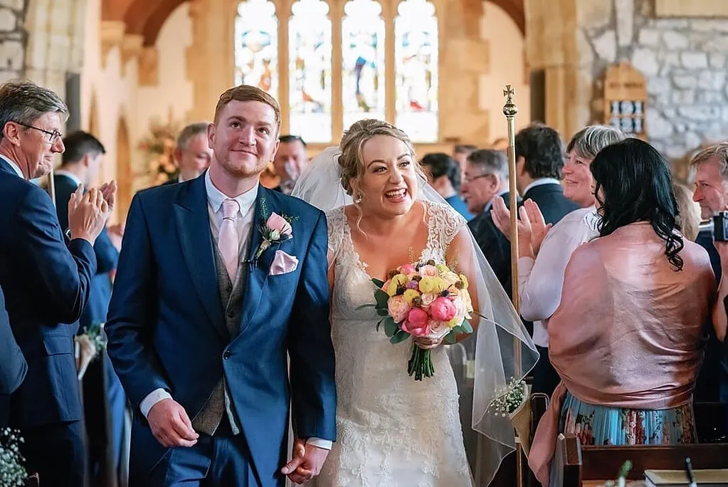 bride and groom leaving the church in Dorset/