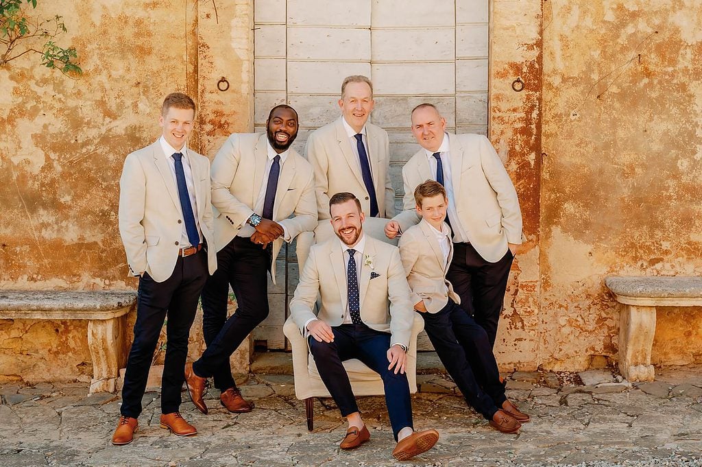 posing by the men at the wedding in Italy