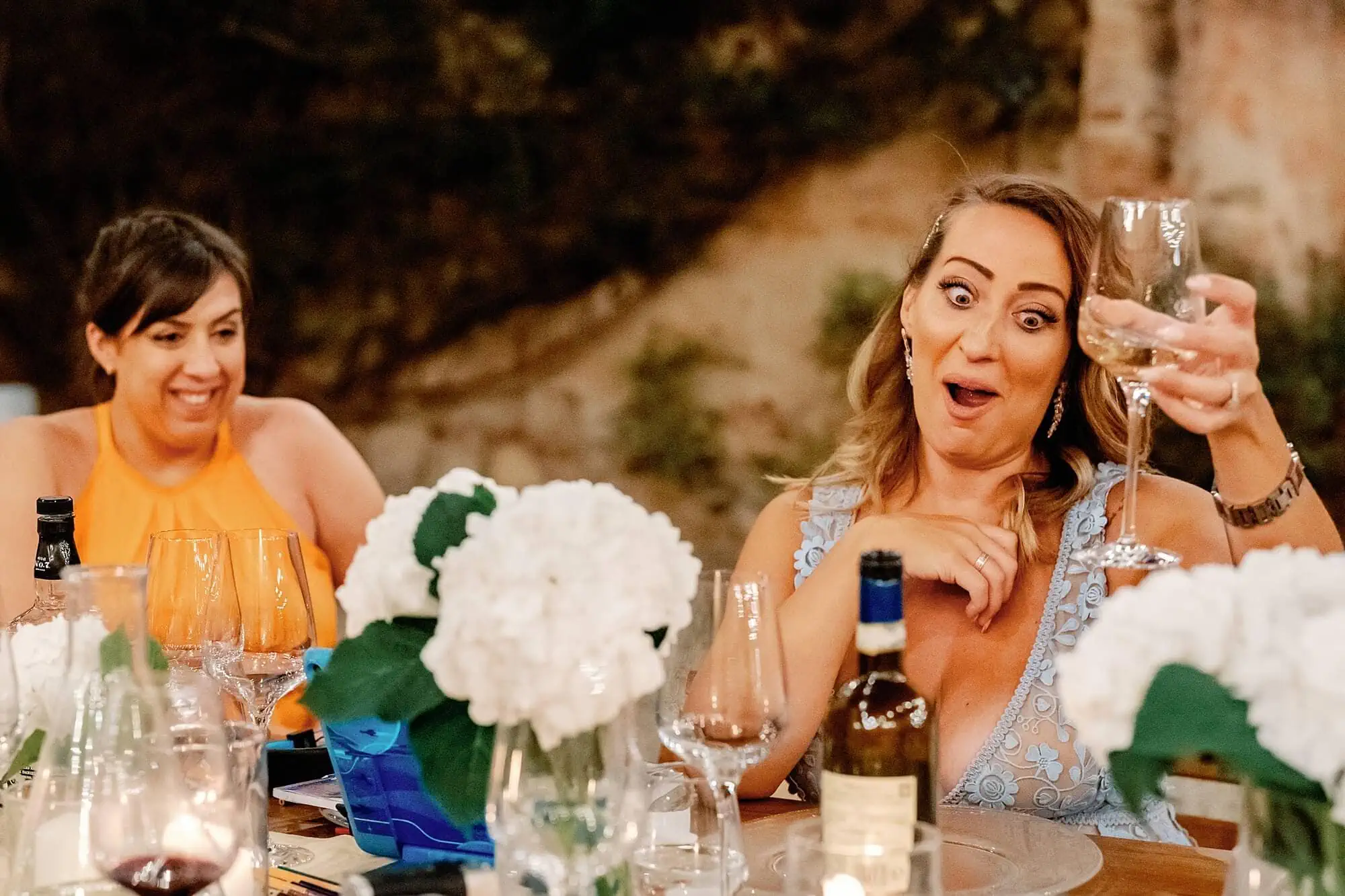 guests having fun during the wedding speeches in Tuscany