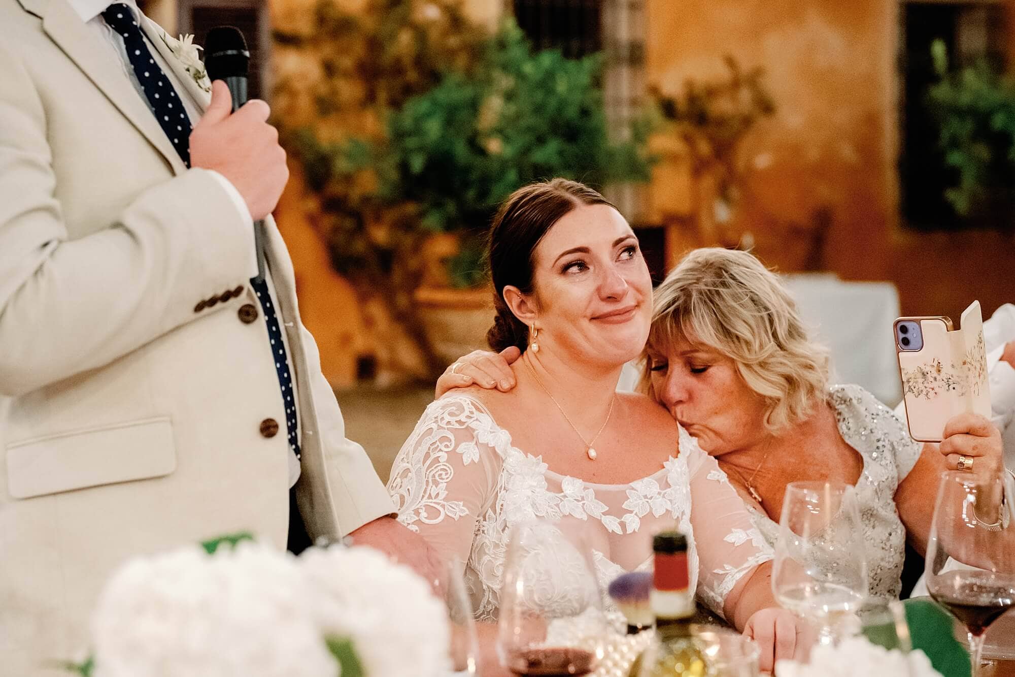 Crying bride comforted by mum during the speeches at an Italian wedding