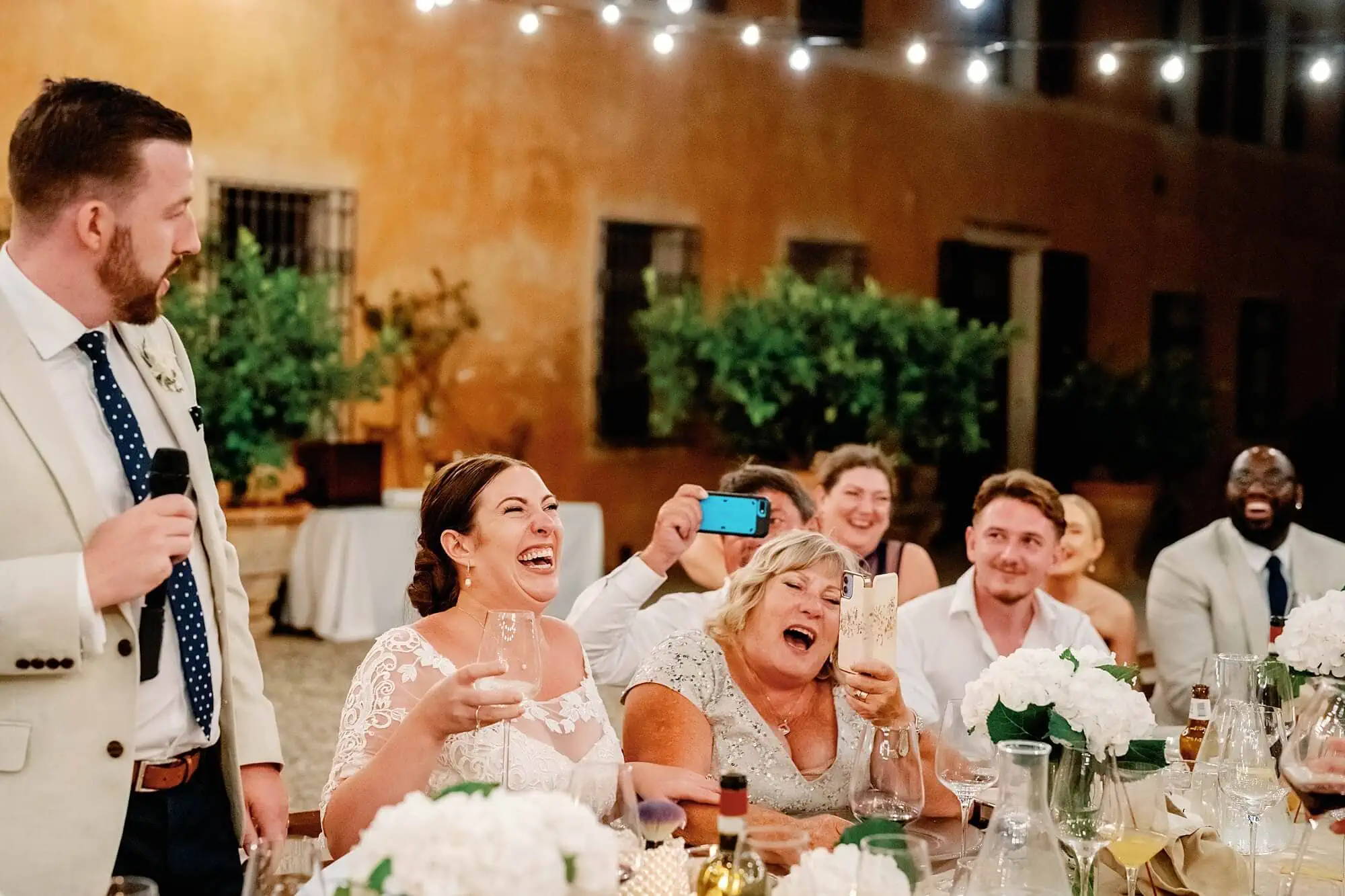 Laughing bride and guests during the speeches in Tuscany