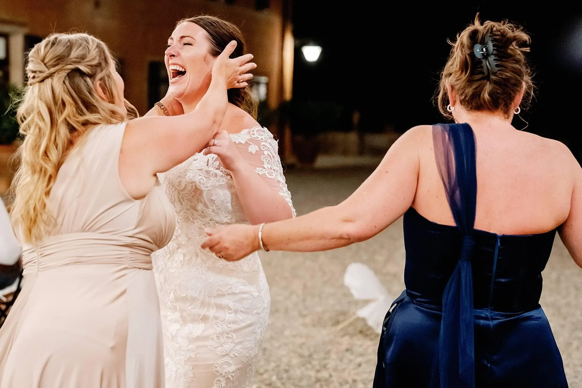 bridesmaids hugging bride after the Italian wedding
