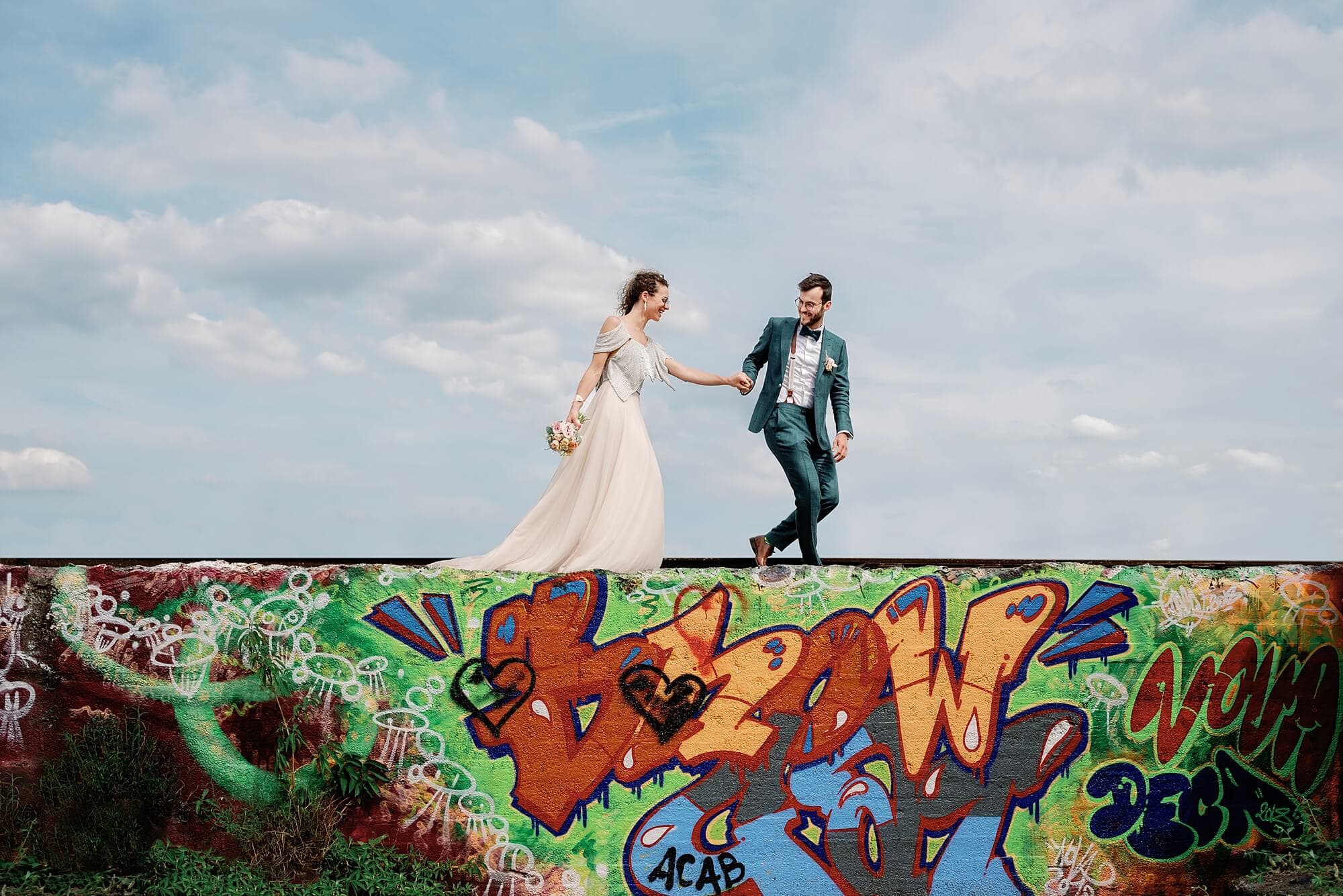 Bride and Groom walking in the wall
