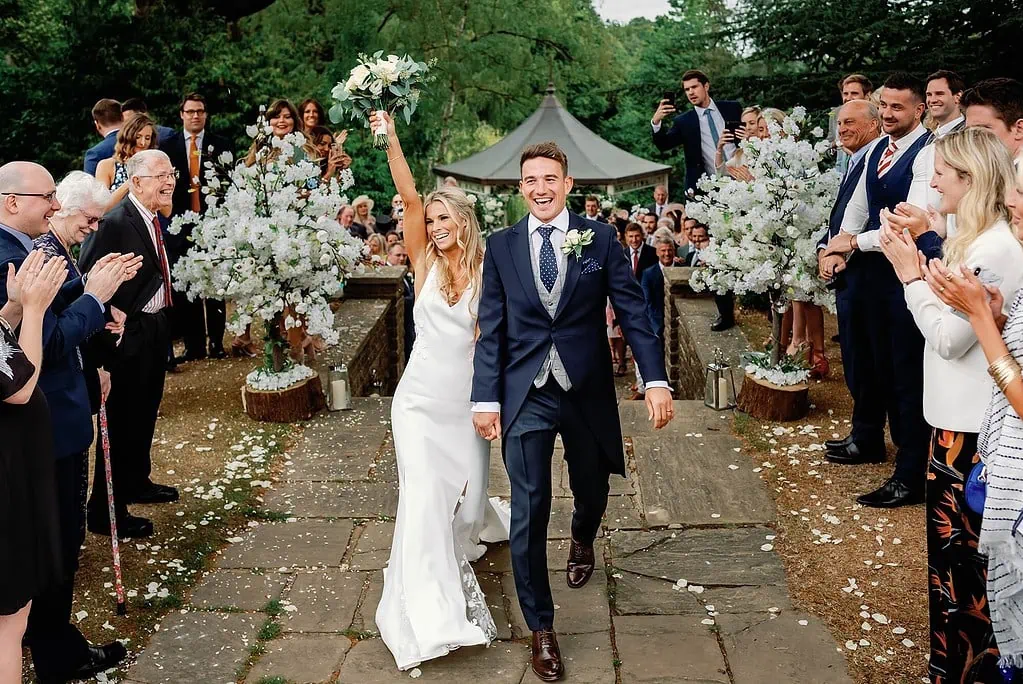 The couple walking after the Confetti at Pennyhill Park
