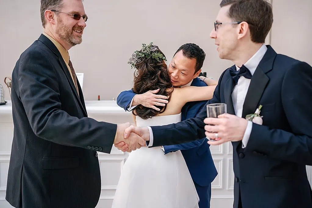 hugs and handshakes at the wedding