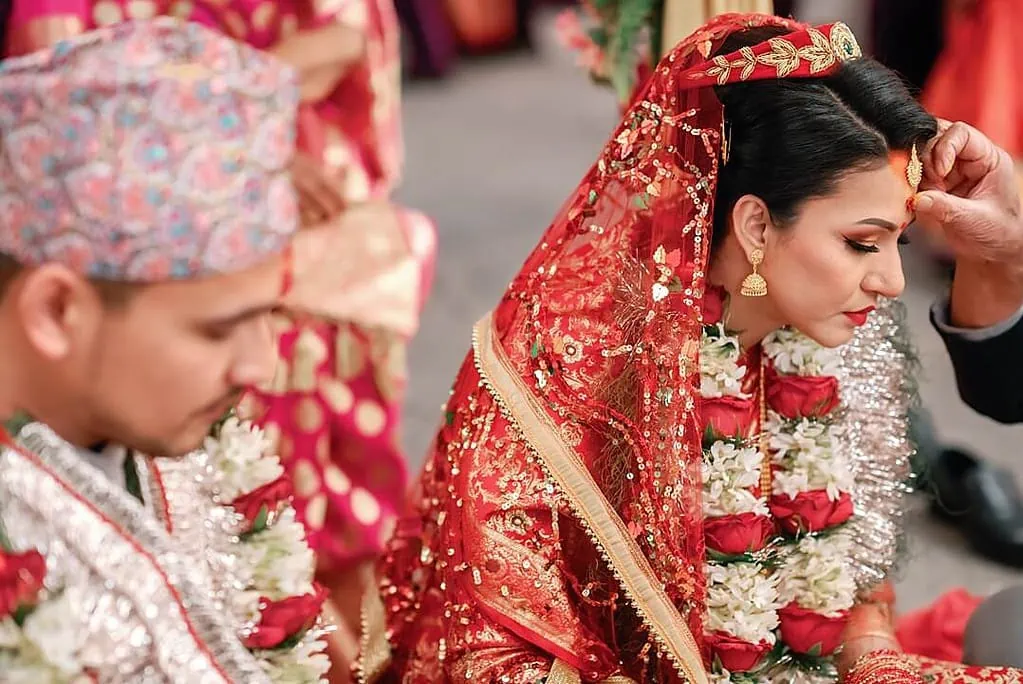 putting tika on the nepalese bride