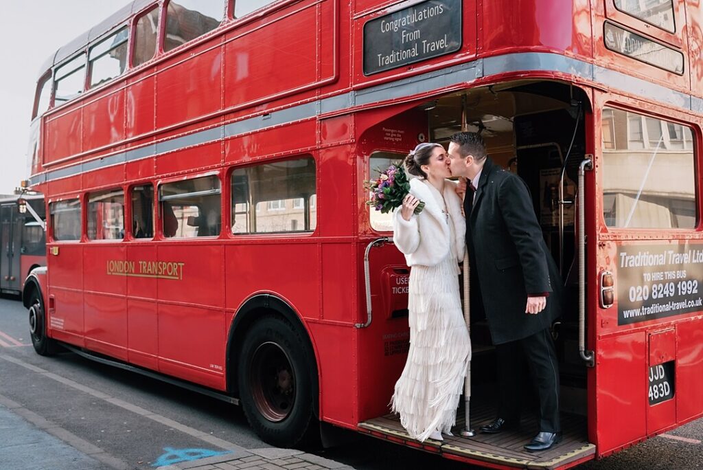 bride and groom kissing on the bus
