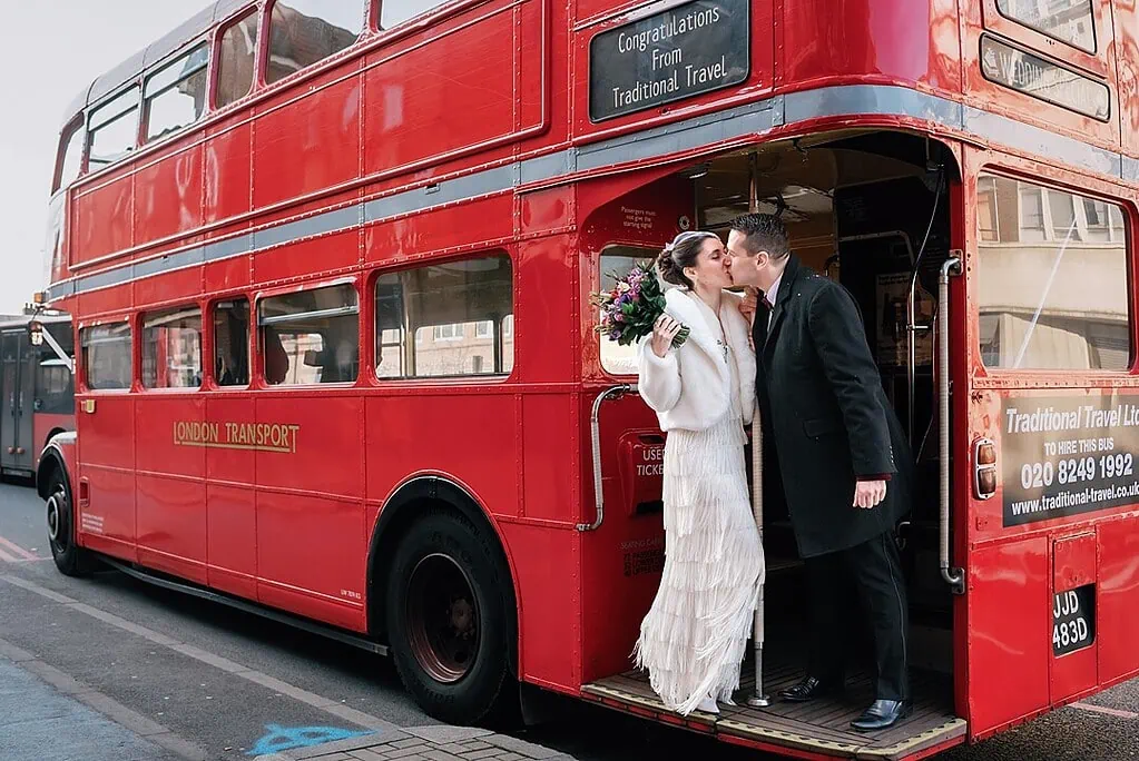 bride and groom kissing on the bus