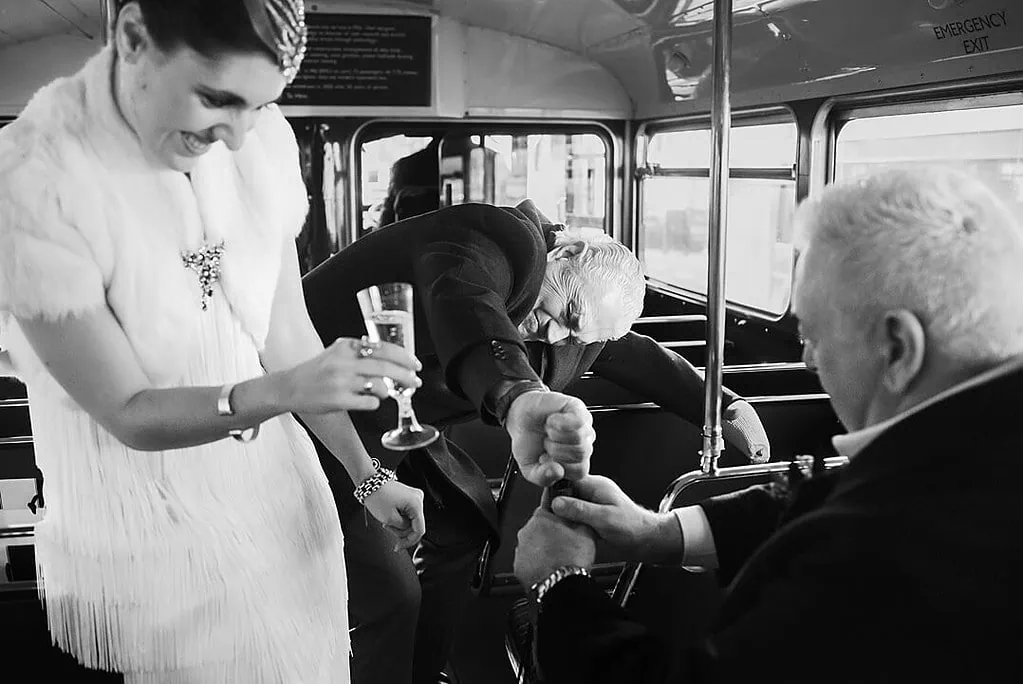 Opening a bottle of champagne on the London Routemaster