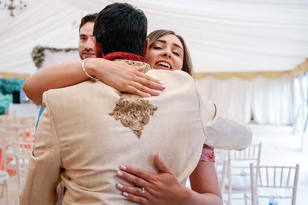 guest hugging the groom at the Indian wedding
