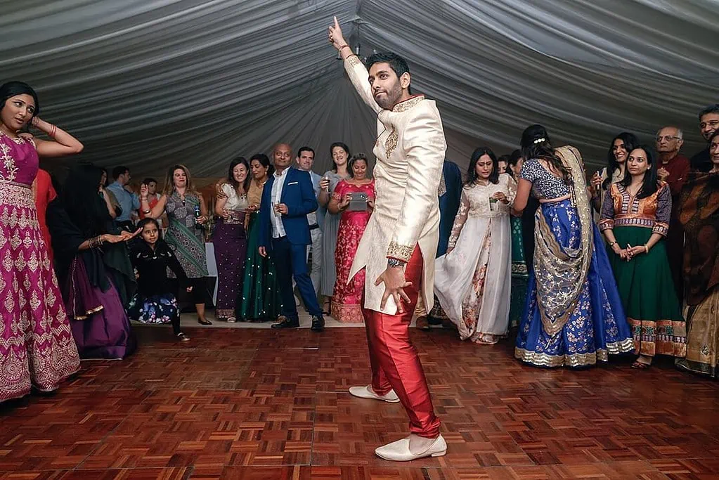 groom dancing at the indian wedding
