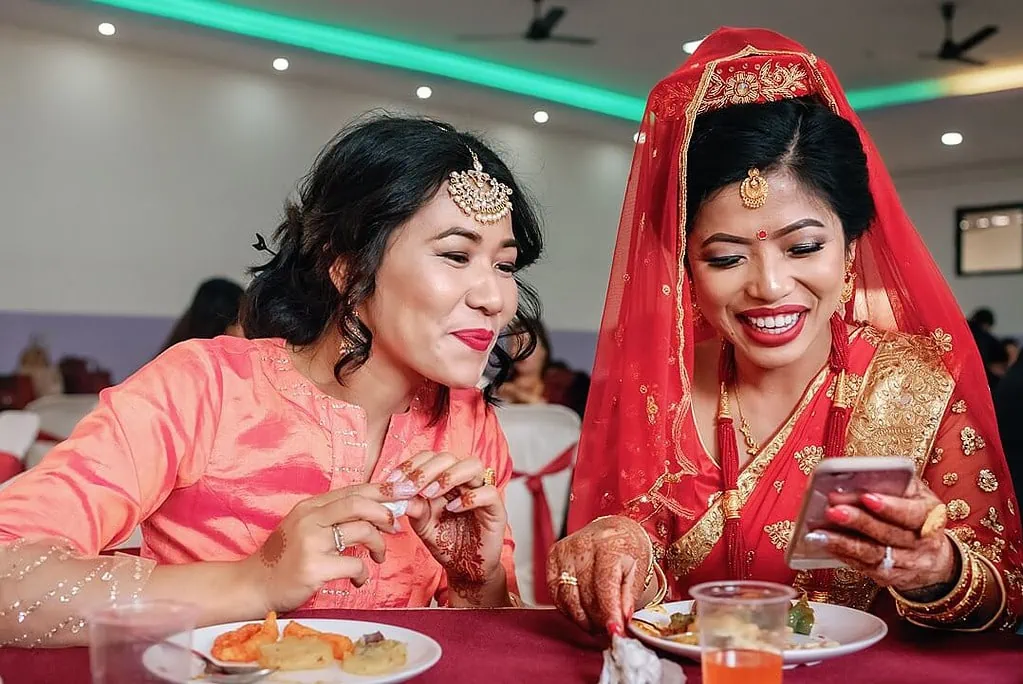 bride and bridesmaid eating before the wedding ceremony in nepal