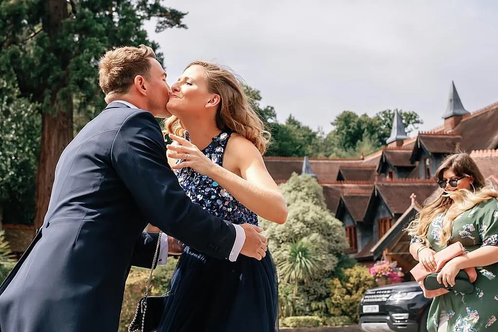 groom embracing wedding guest at Pennyhill