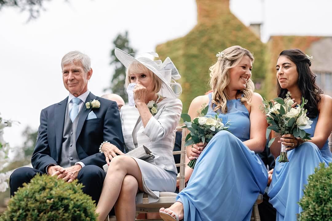 the bride's parents and bridesmaids at the wedding ceremony