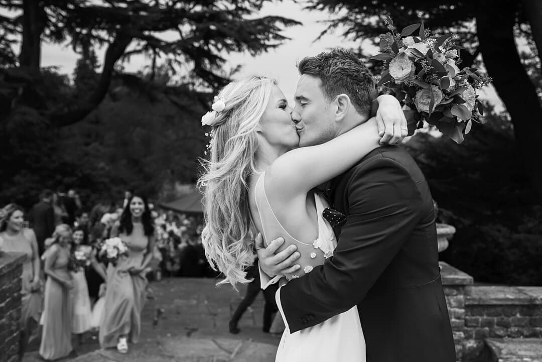The bride and groom kissing at Pennyhill Park