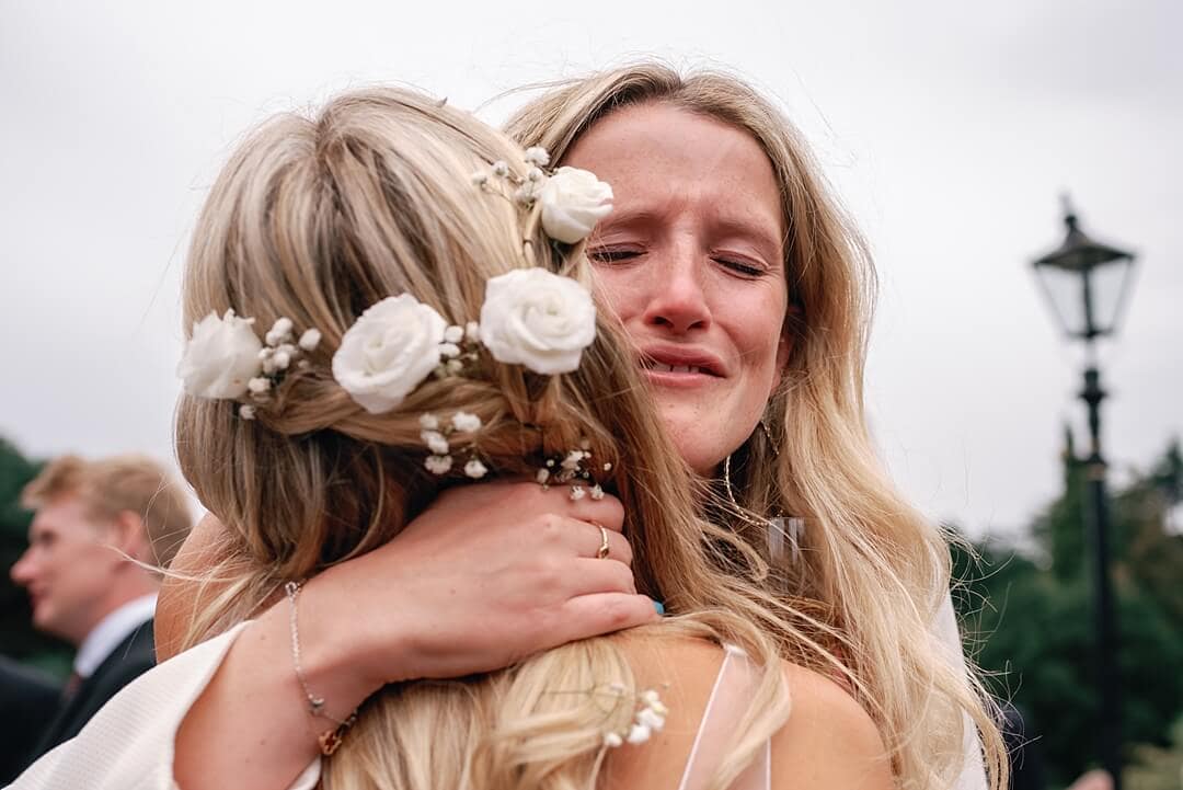 emotional guest hugging the bride