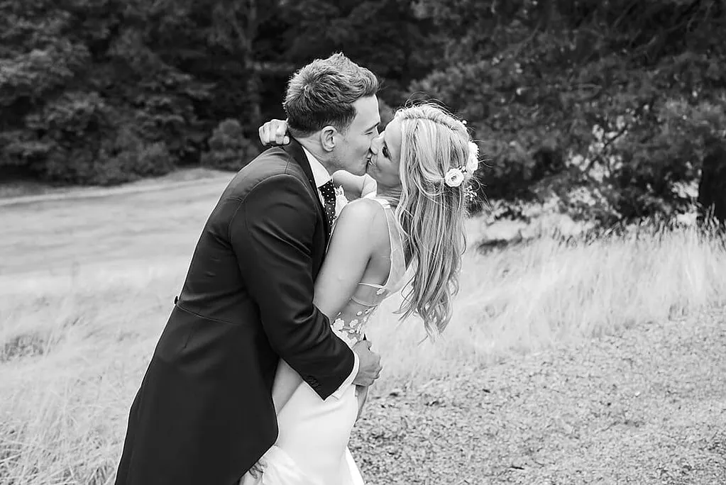 bride and groom kiss at Pennyhill Park