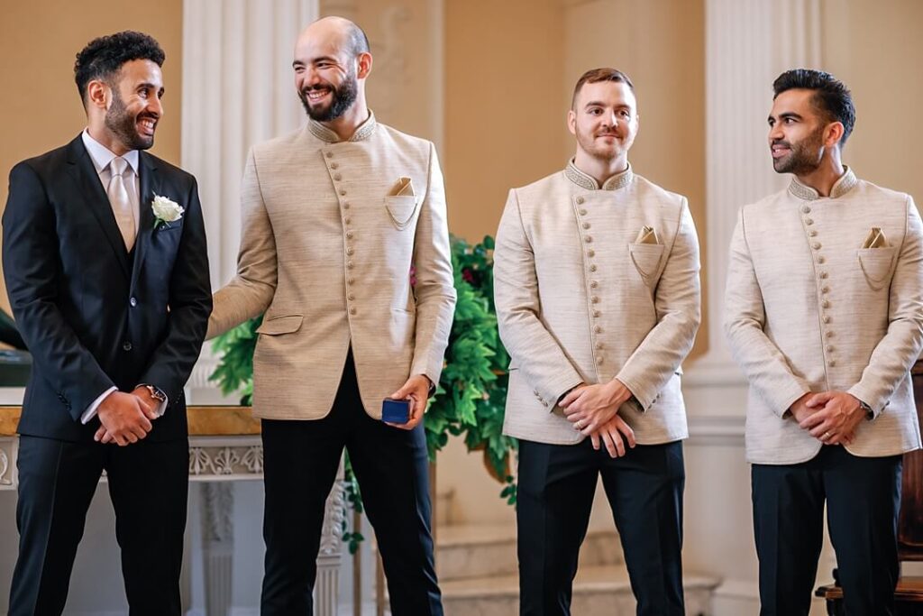 The groom and groomsmen waiting in the Great Hall at Syon Park