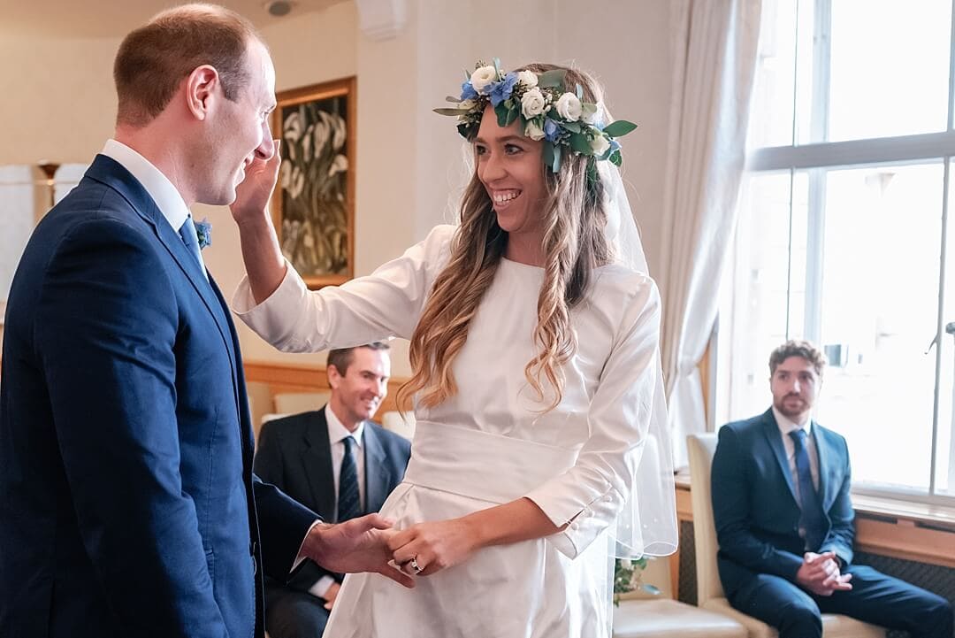 laughing bride wiping away tears of groom at Wandsworth Town Hall Wedding Photography