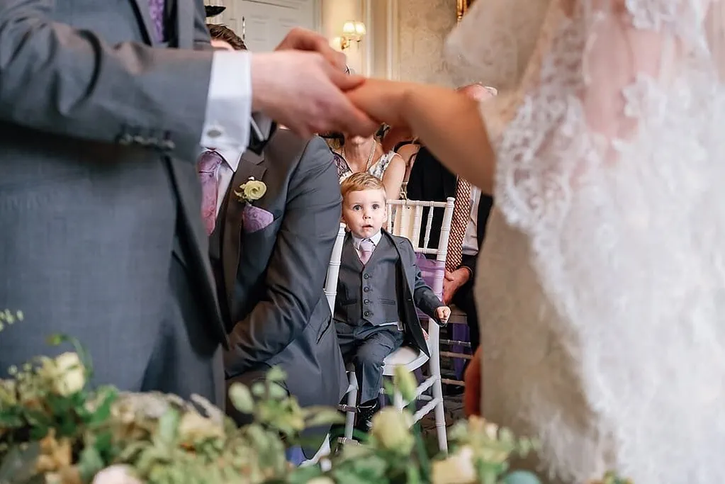 page boy getting excited during the wedding ceremony