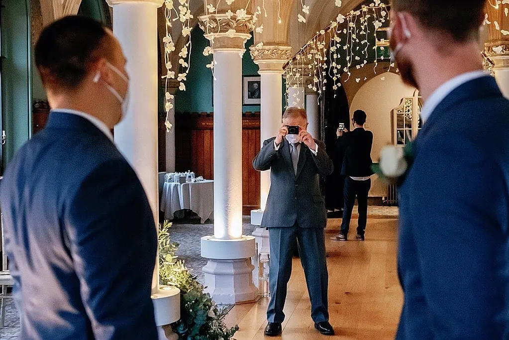 taking photograph of the groom and best man