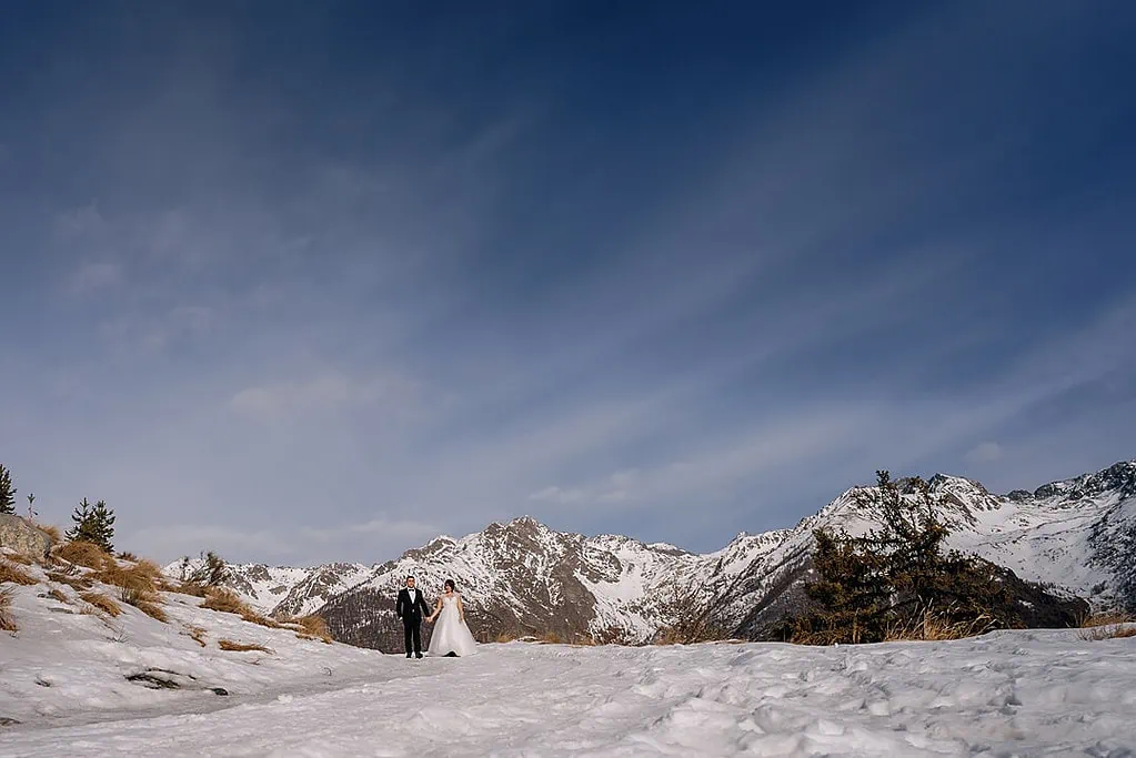 bride and groom walking in the alps