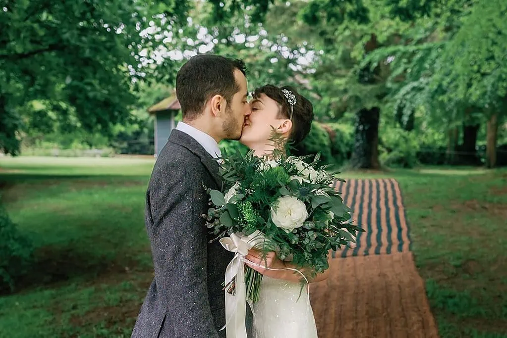 bride and groom kiss at Bittenham Springs