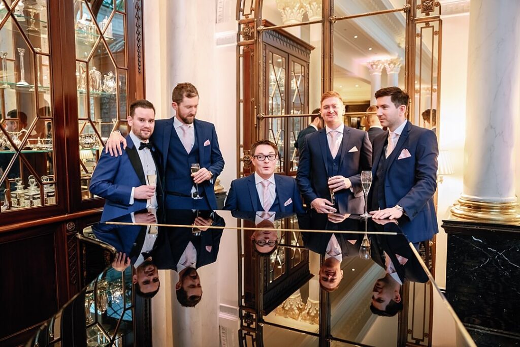 The groom and groomsmen having a drink at The Savoy Hotel Wedding