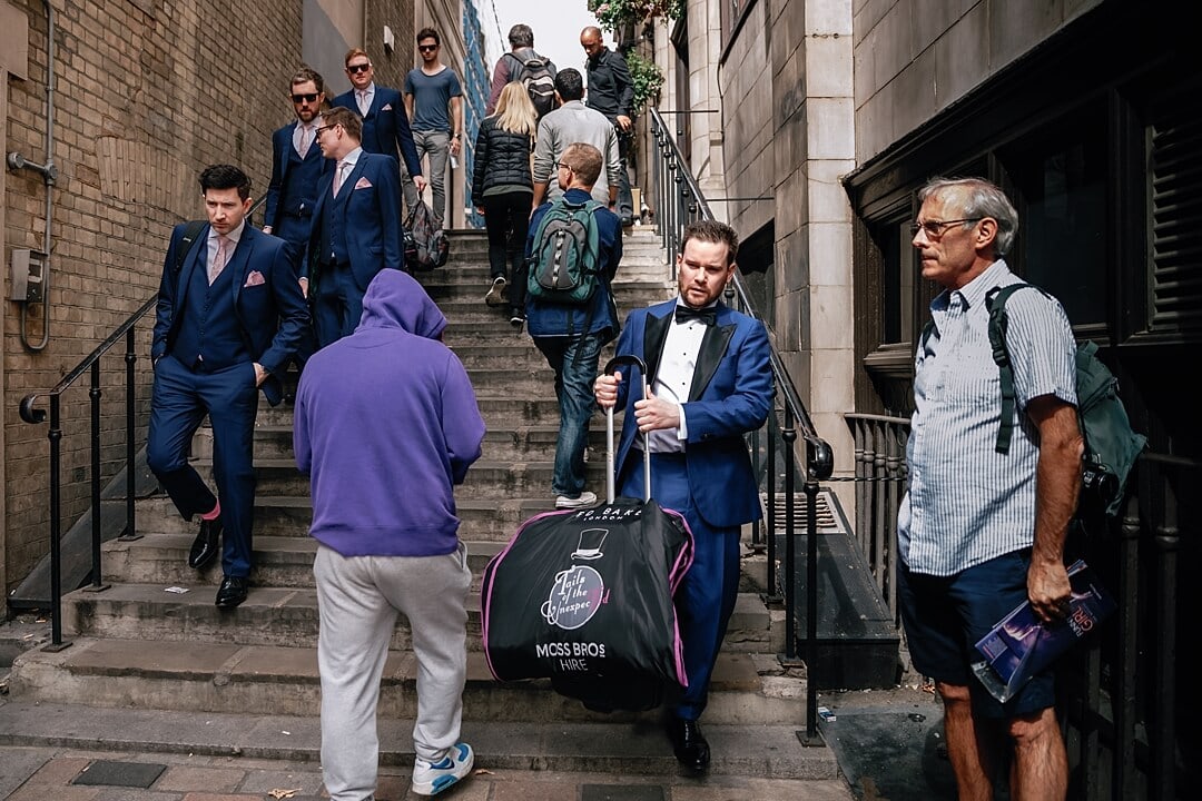 The groom walking to the Corinthia Hotel