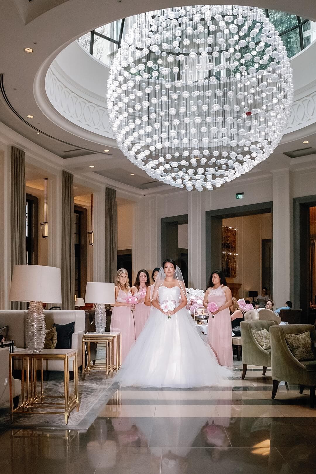 bride and bridesmaids getting ready to go to the ceremony at The Corinthia Hotel