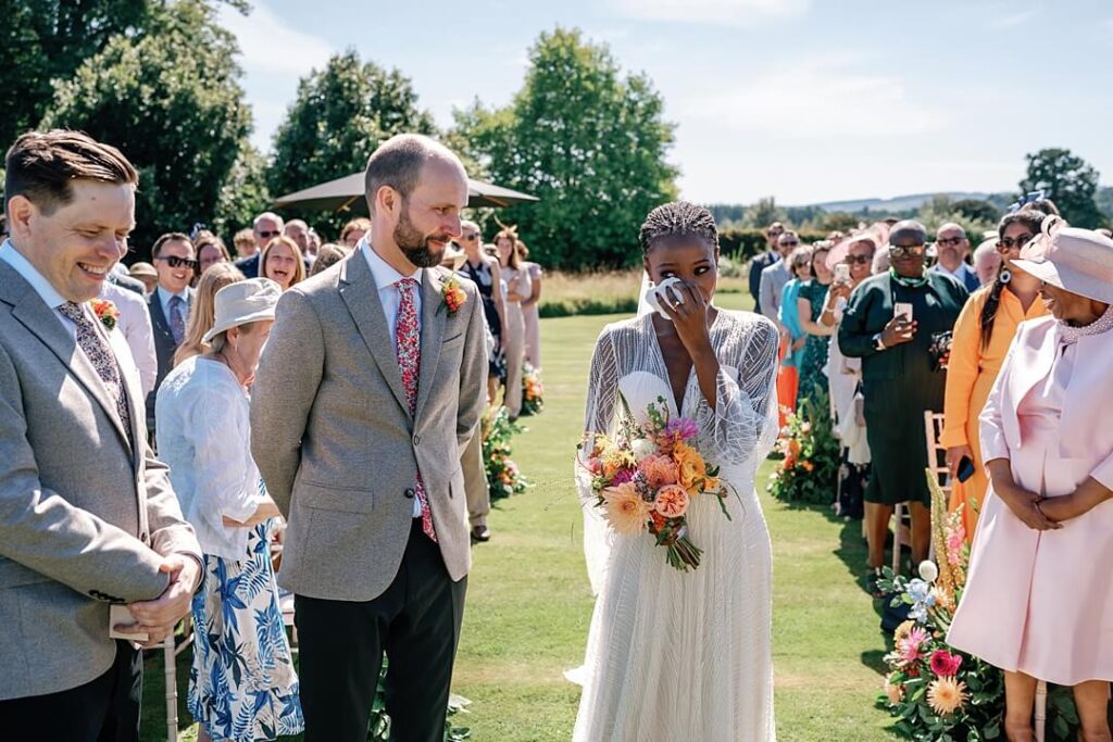 emotional bride wiping away tears at cowdray house