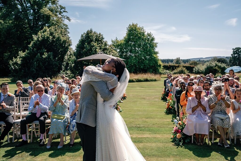 couple hugging at the end of the cermeony ar cowdray house