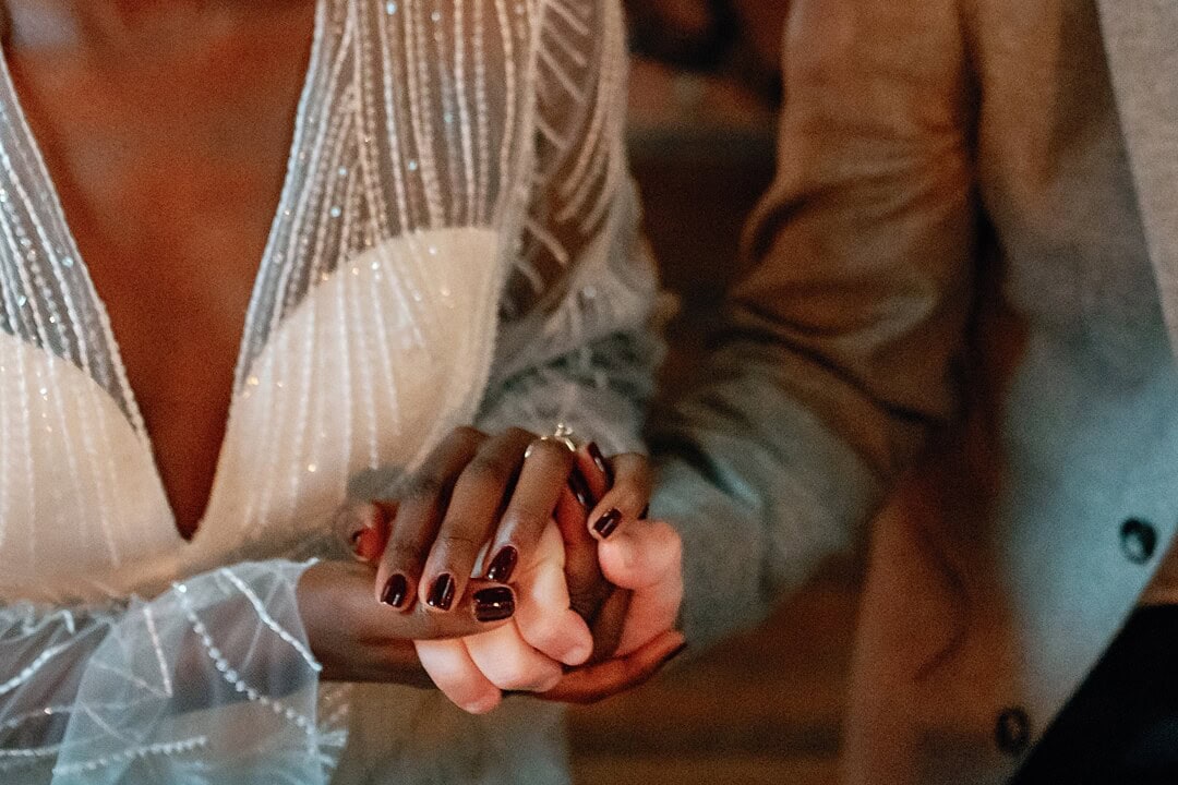the bride and groom holding hands in buck hall