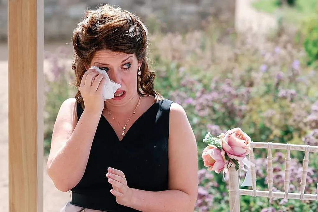 crying bridesmaid at the wedding ceremony