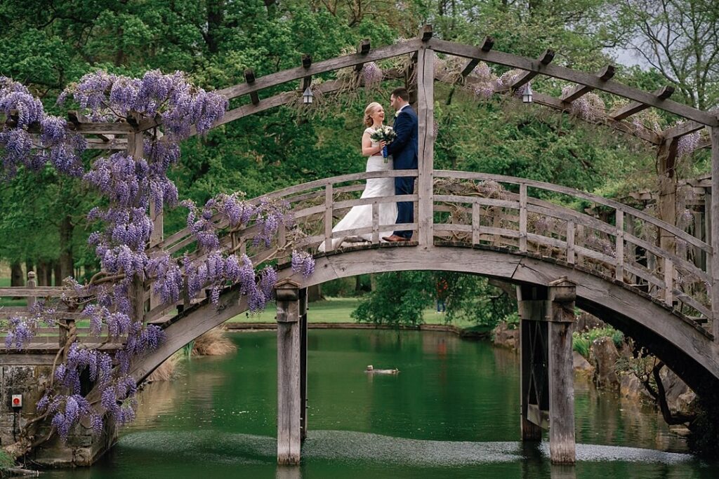 couple portrait on the bridge at Great Fosters