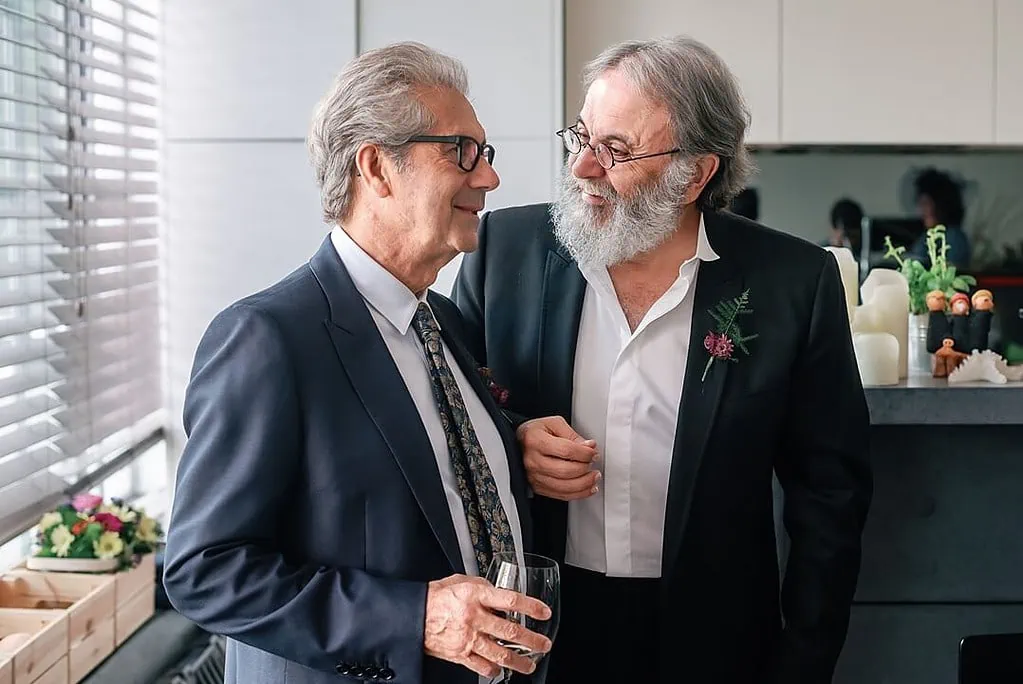 the fathers having a drink and sharing a joke before the wedding