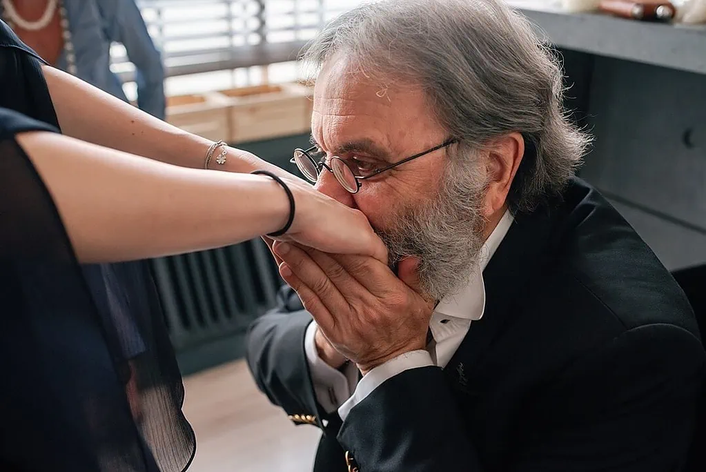 Father kissing his daughter's hand before the London wedding