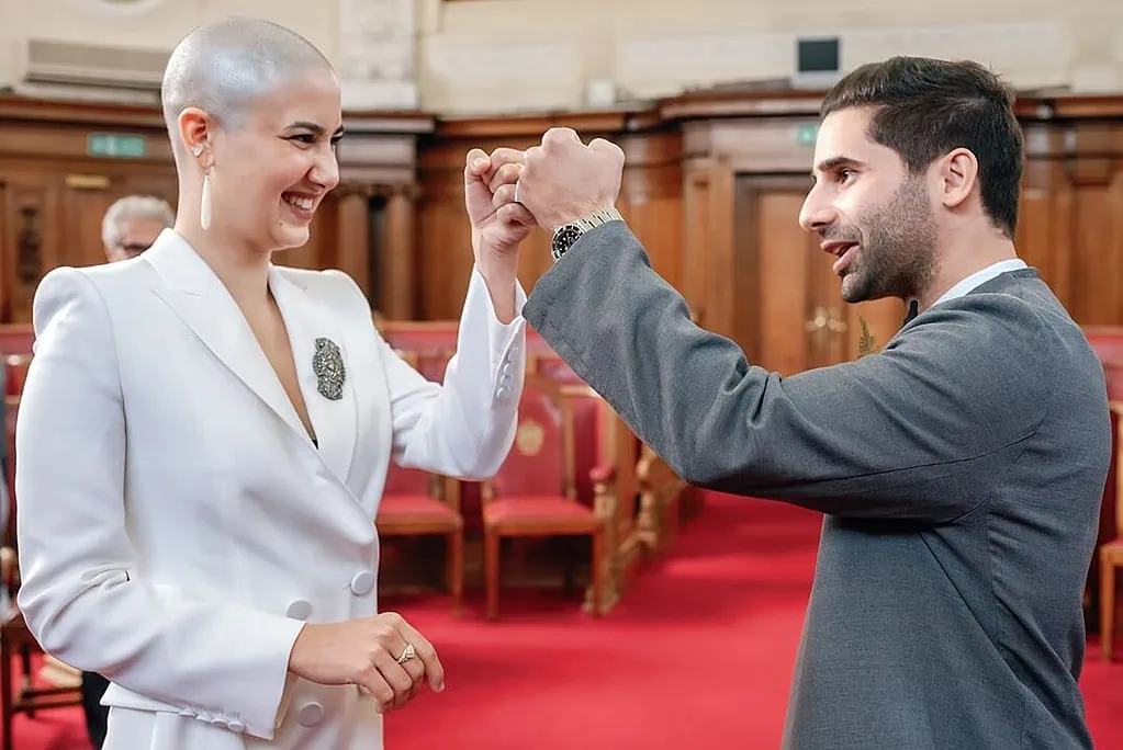 bride and groom fist bump at Islington Town Hall