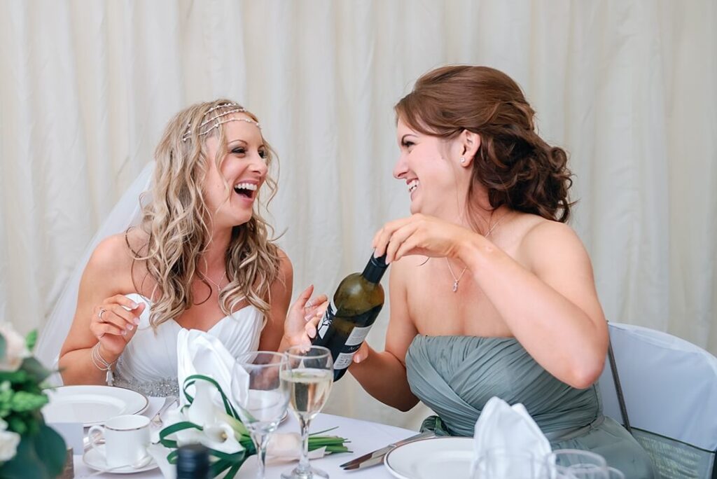 bride and bridesmaid share a joke