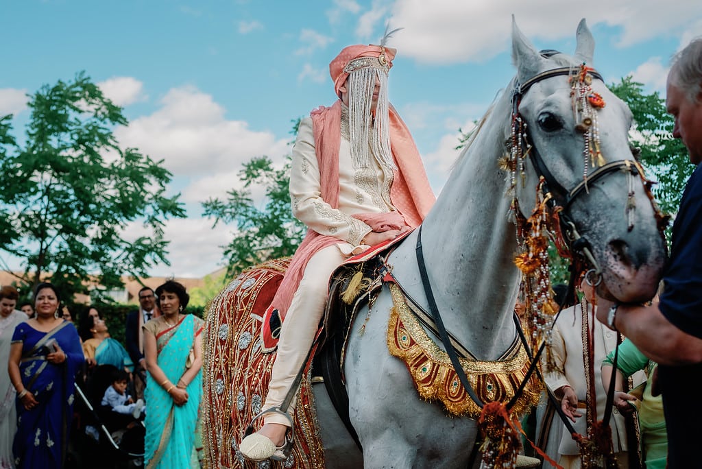 The Groom wearing a Sehra during the baraat