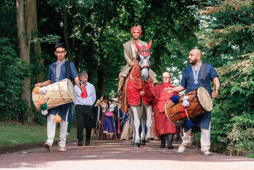 sikh groom riding a horse to the wedding ceremony in Knutsford
