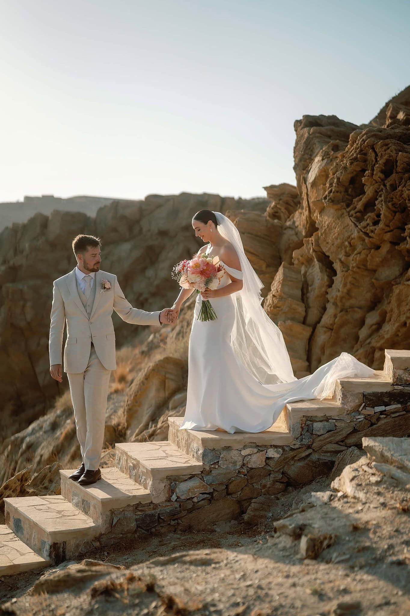 Bride and Groom walking down steps in Ios, Greece